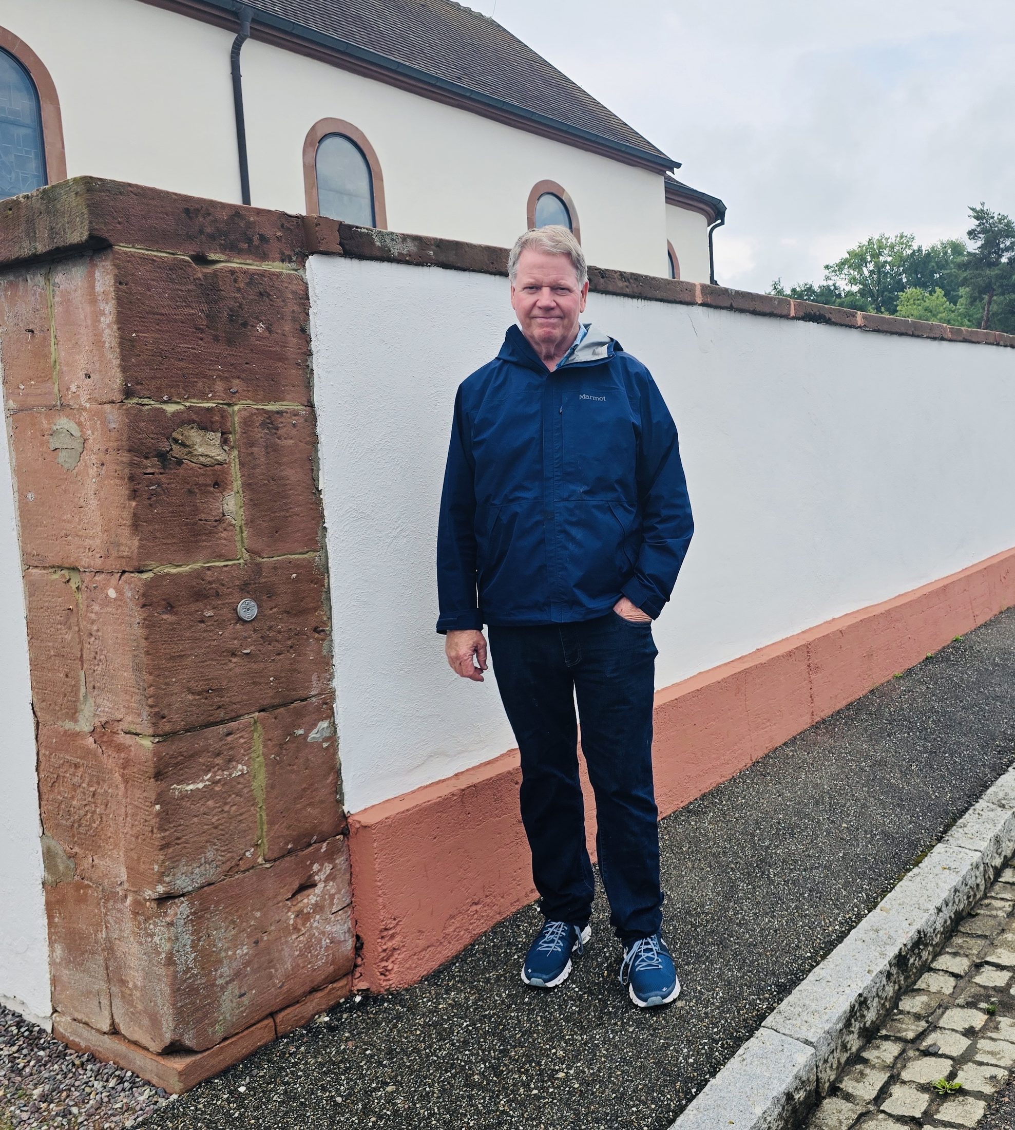 Tom Breen on a 42nd Rainbow Division tour at the wall in Neubourg, France, where an 88 shell nearly killed his father, Vernon C. Breen of the 222nd Infantry Regiment